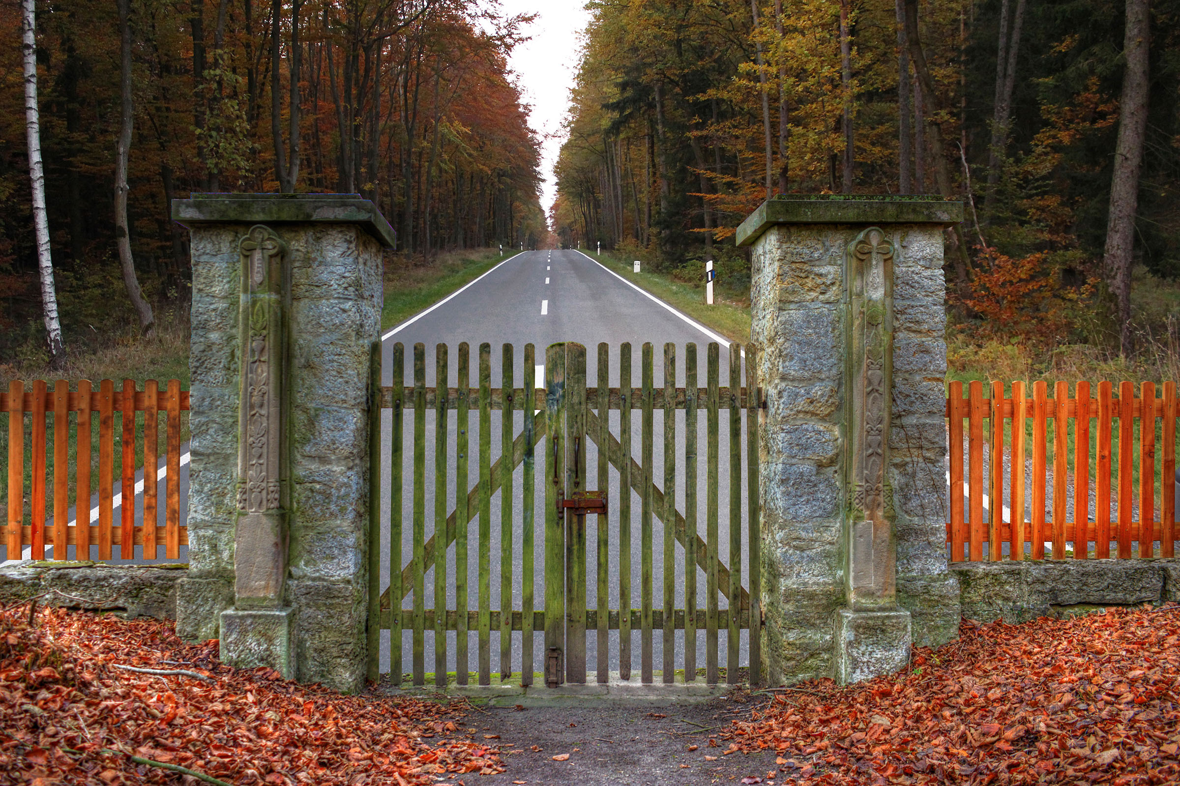 image of fence with lock and road ahead